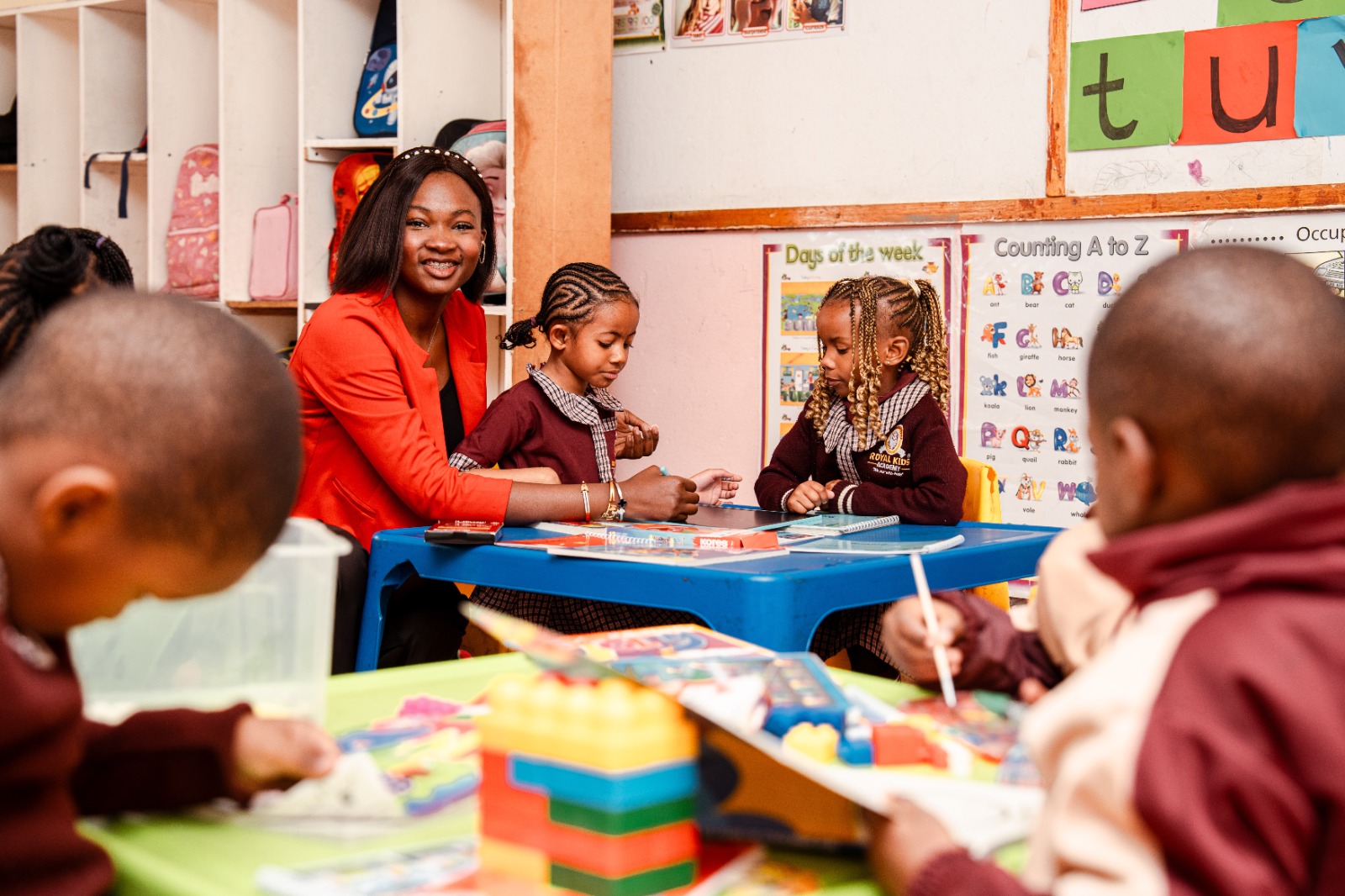 A teacher sitting with Pre-Primary pupils at story time